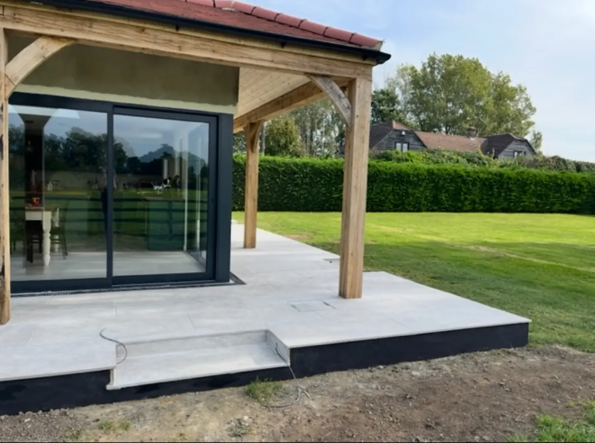 Oak-framed garden room with a stone terrace